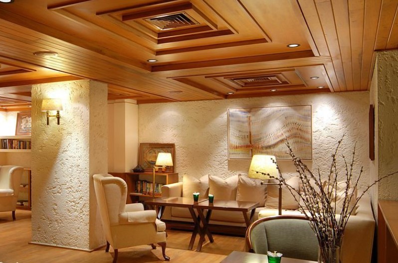 Коричневый деревянный потолок в интерьере гостиной