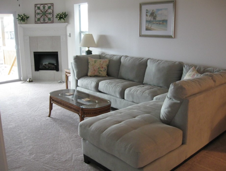 Угловой диван позволит выполнить зонирование и отделить гостиную от кухни