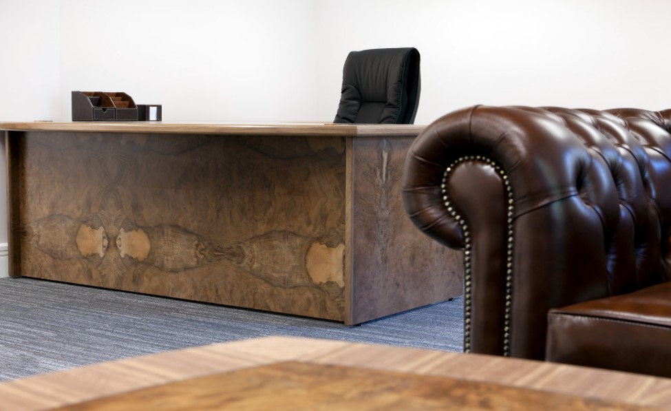Рядом с деревянным столом можно поставить кожаный диван