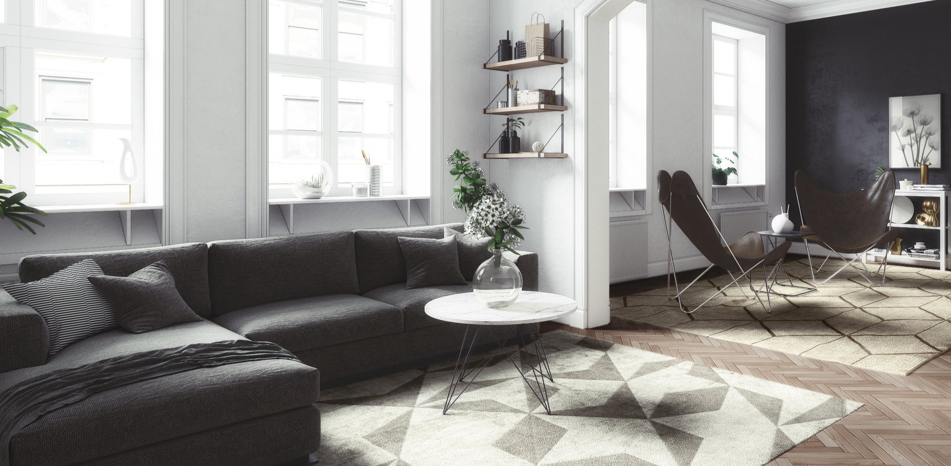 Темно-серый диван стильно смотрится в интерьере белой комнаты