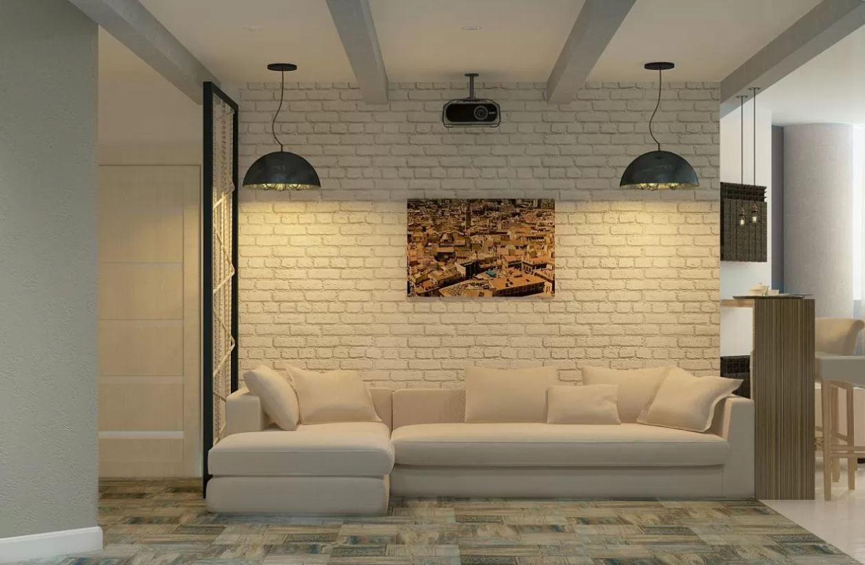 Белую кирпичную стену и белый диван интересно оттеняет освещение и пестрая картина 