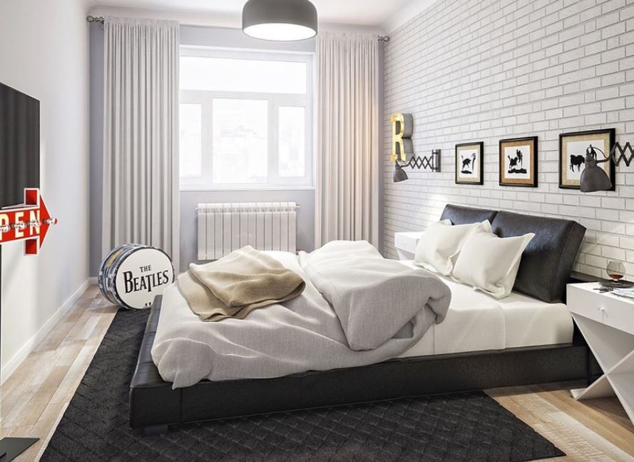 Светлую отделку спальни элегантно подчеркивает кровать и ковер черного цвета