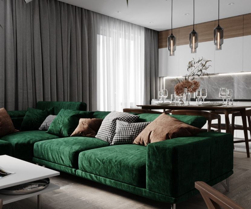 Зеленый диван как элемент зонирования между кухней и гостиной